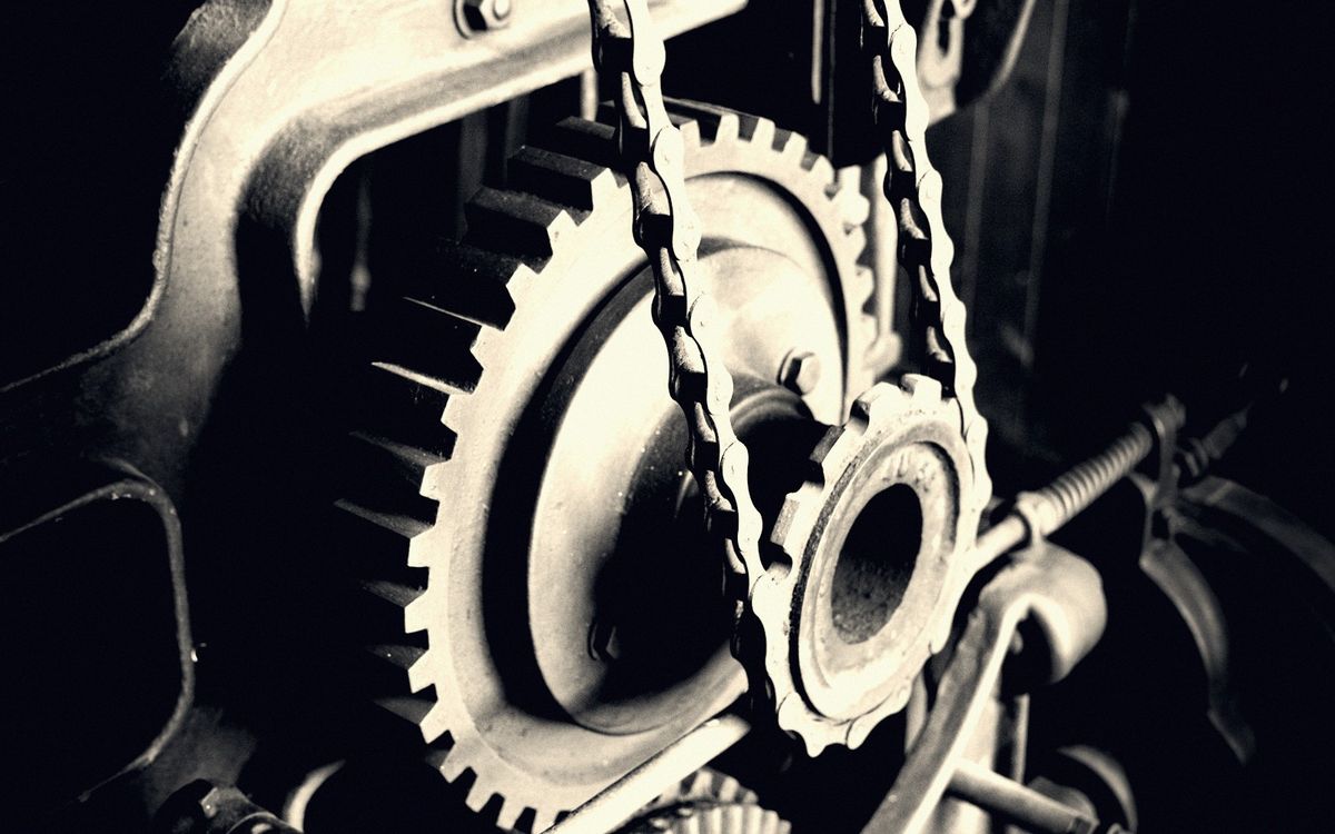 Close-up of gears and chain inside the machine workshop