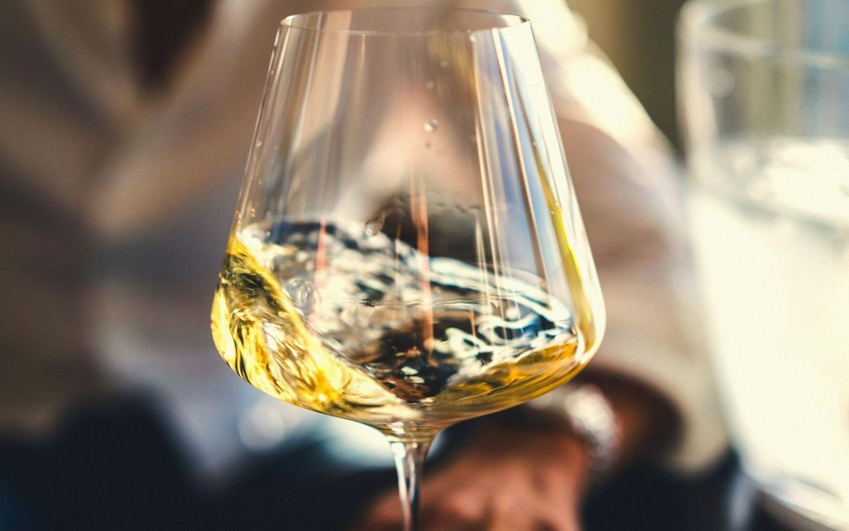 Terrace along the Loire quays at golden hour, glasses on the table